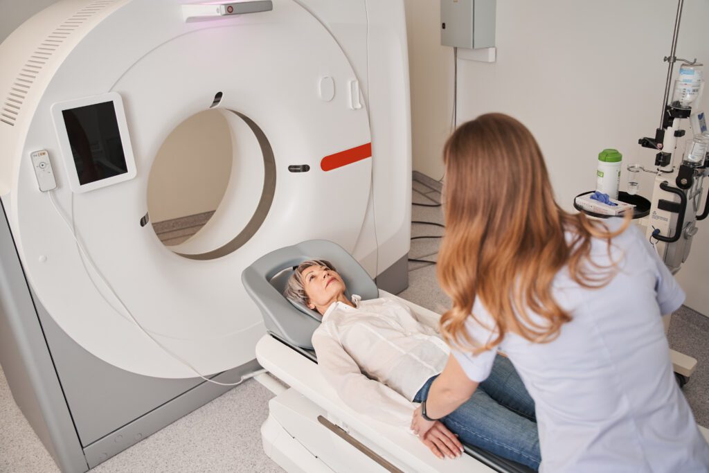 Mature female patient prepares for CT scan.